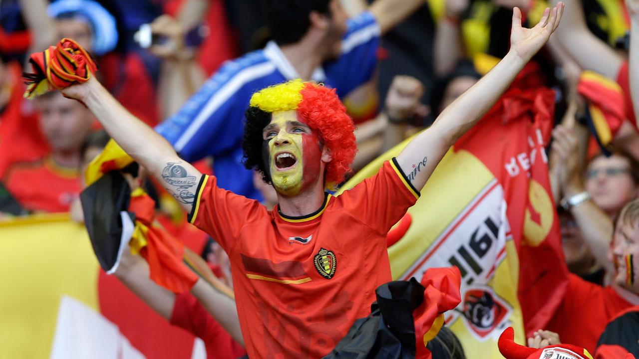A Belgium fan dons a black, yellow and red wig to support his side during the team's match against Algeria at the World Cup.