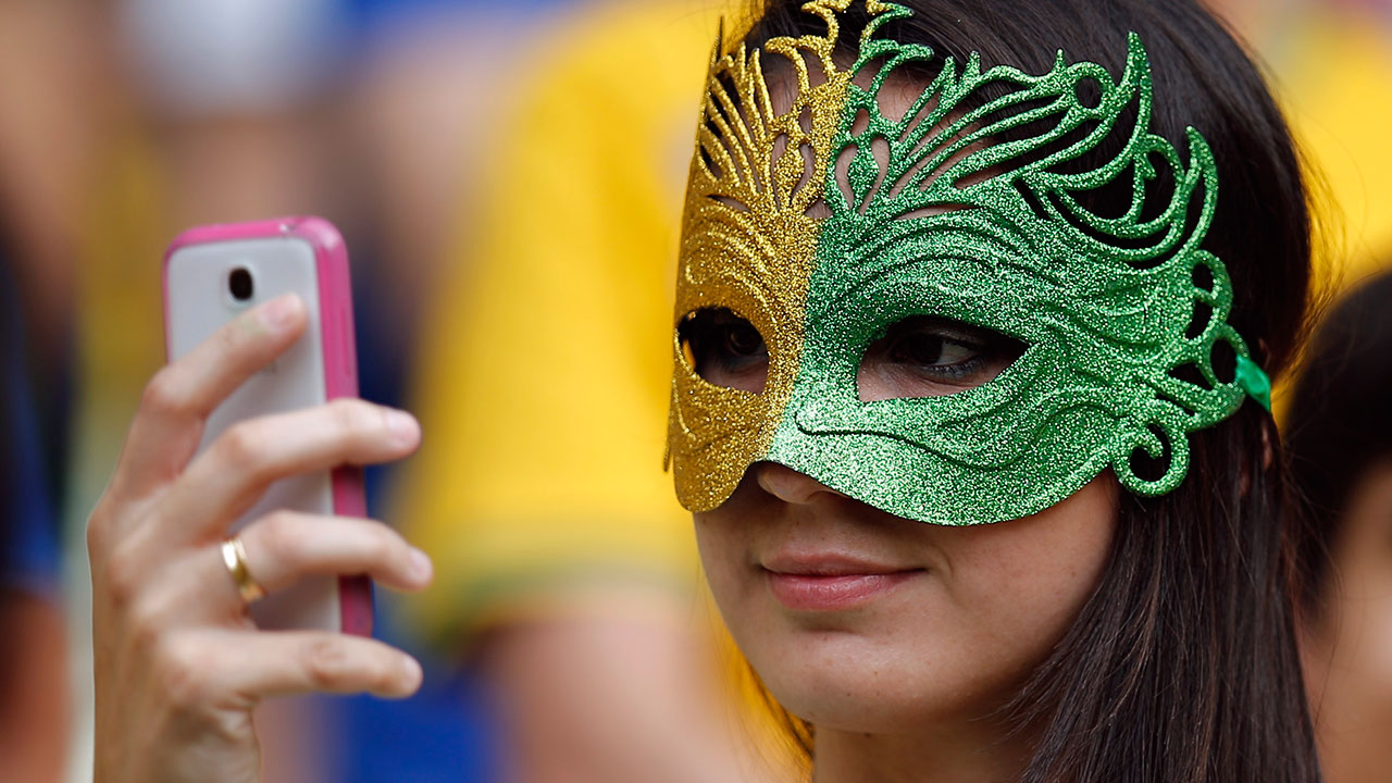 A Brazilian fan takes a 'selfie' of herself before the group A World Cup soccer match between Brazil and Mexico.