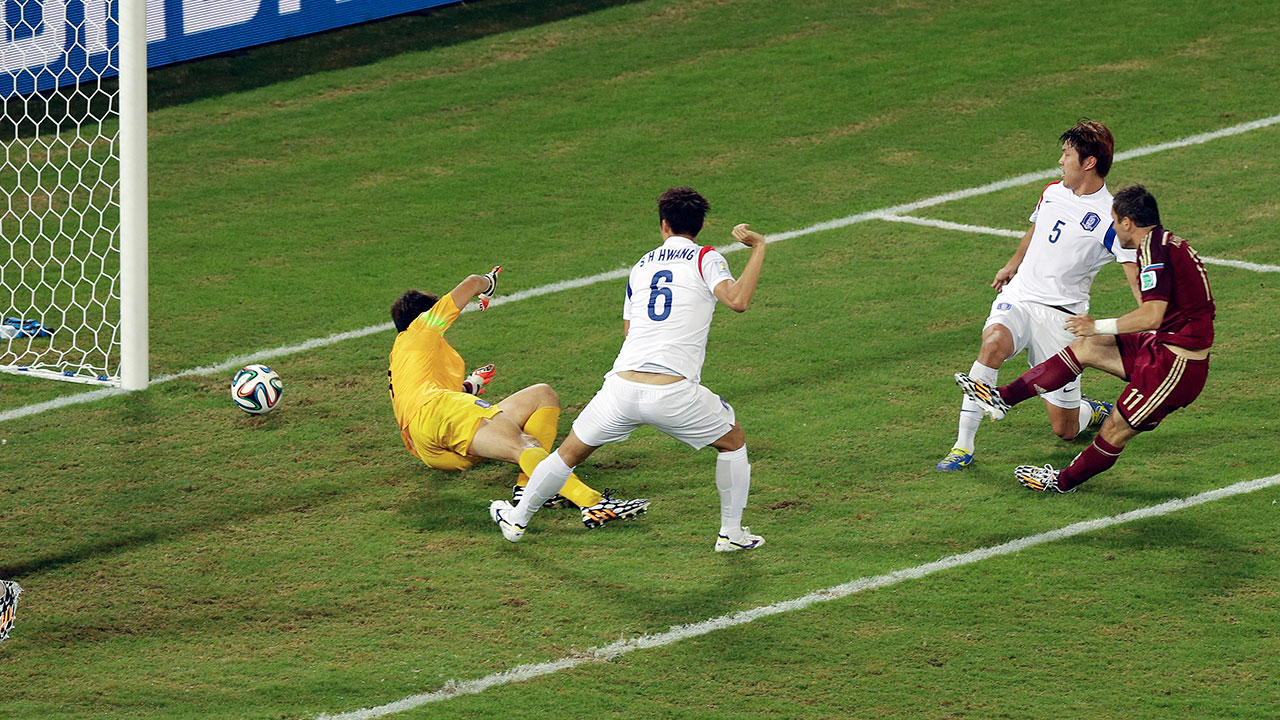 Russia's Alexander Kerzhakov, right, scores his side's first goal past South Korea's goalkeeper Jung Sung-ryong.